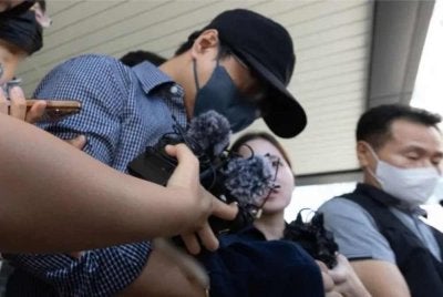 Bu yang didakwa menutup kes orang hilang secara palsu di Pulau Jeju ketika meninggalkan Mahkamah Daerah Jeju pada 25 Ogos lalu. - FOTO: Korea JoongAng Daily.
