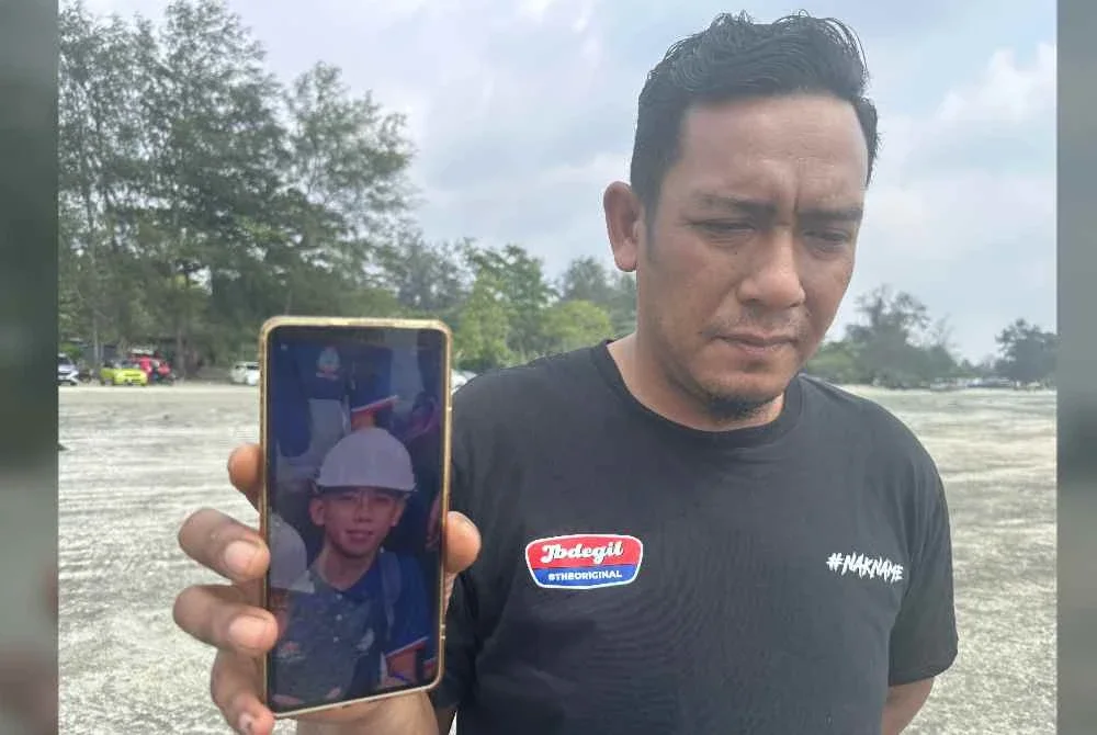 Sharizal menunjukkan gambar anak saudaranya, Muhammad Haiman Fitri.