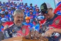 Akmal menuangkan air kepada Zahid ketika berucap pada penutup konvoi bermotor Karnival Anak Muda di MiTC pada Ahad.