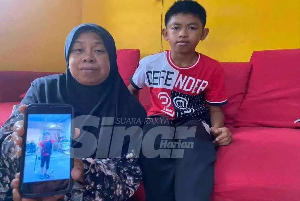 Norhabibi menunjukkan gambar arwah Mohamad Amiruddin Anwar ketika ditemui di rumahnya di Kampung Langgar, Kota Bharu pada Isnin. Foto:SINAR HARIAN/HAZELEN LIANA KAMARUDIN