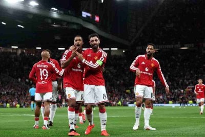 Para pemain meraikan kejayaan United menundukkan Sabah 4-0 dalam saingan Liga Juara-Juara di Old Trafford pada Jumaat. Foto: AFP