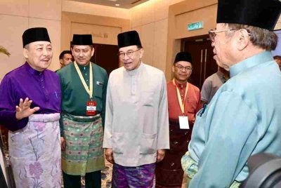 Hajiji mengiring Anwar dan Abang Johari ketika menghadiri MTPMA63 di SICC, Kota Kinabalu.