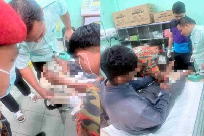 Pasukan bomba berusaha mengeluarkan besi yang tertusuk pada kaki mangsa semasa menerim rawatan di Hospital Tambunan.