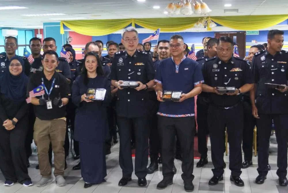 Mohd Jazri (tiga dari kanan) dan Mi-Chelle(tiga dari kiri) bergambar kenangan bersama Swee Sake (tengah) dan sebahagian anggota polis IPDTL.