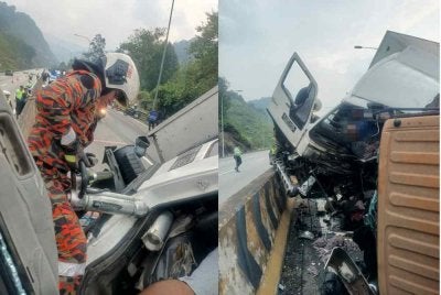 Anggota bomba sedangmengeluarkan mangsa yang tersepit dalam kemalangan selepas Terowong Menora