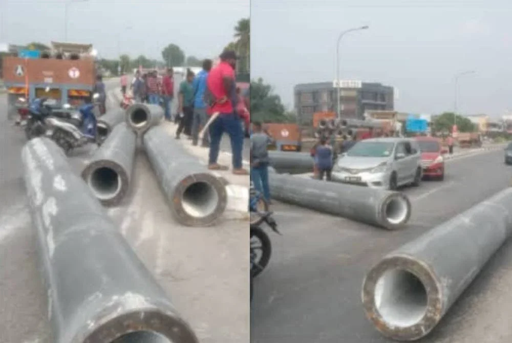 Muatan besi cerucuk yang dibawa sebuah lori terjatuh di jalan.