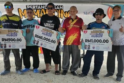 Mohd Saiful (tiga dari kanan) bersama pemenang Pertandingan Memancing Terbuka Kuala Selangor di Pantai Sungai Kajang.