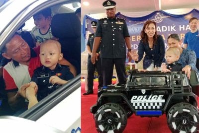 Hafiz bersama bapanya ketika berada dalam kereta peronda dalam program PDRM bersama Make A Wish Malaysia di IPD Petaling Jaya pada Khamis.