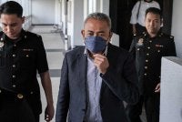 Adi Azuan (depan, kanan) mengaku tidak bersalah selepas pertuduhan dibacakan di hadapan Hakim Suzana Hussin. Foto: Bernama 