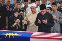 Anwar dan isteri semasa menziarahi jenazah Allahyarham Dr Hasmah. Foto Facebook Anwar Ibrahim