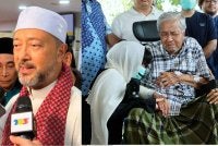 Mukhriz Mahathir (kiri). Tun Dr Mahathir (kanan) ditenangkan ahli keluarga ketika menziarahi pusara isterinya Tun Dr Siti Hasmah Mohd Ali di Pusara Negara Presint 20 pada Khamis. 