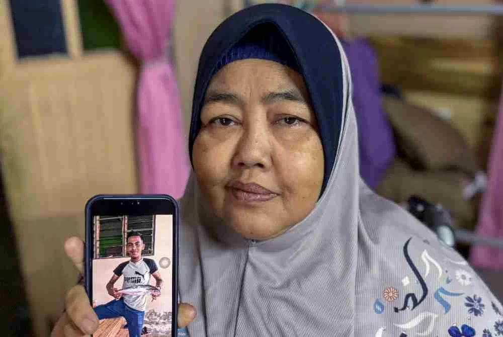 Junaida menunjukkan gambar adik bongsunya, Al Zubair yang maut dalam kemalangan di Gerik, Perak petang semalam, kepada wartawan Bernama di rumahnya di Kampung Tok Sadang, Kota Bharu pada Isnin. Foto: Bernama
