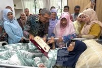 Wan Ahmad (dua dari kiri) menyampaikan sijil penghargaan atas jasa dan perkhidmatan kepada Siti Zaitun (kanan) pada Khamis.