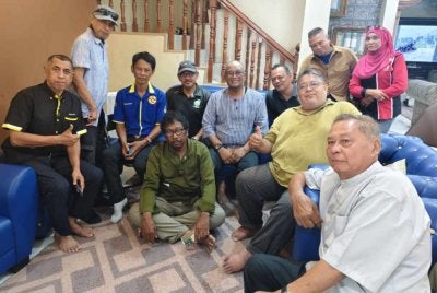 Nash (duduk empat dari kiri) mengabadikan kenangan dengan ahli NGO yang melawatnya di Seksyen 7, Shah Alam pada Jumaat.