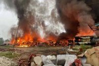 Anggota bomba menjalankan operasi pemadaman kebakaran di tapak pelupusan sampah di Kampung Pasir Putih, Pasir Gudang yang masih berterusan sejak malam Rabu. - Foto JBPM Johor 