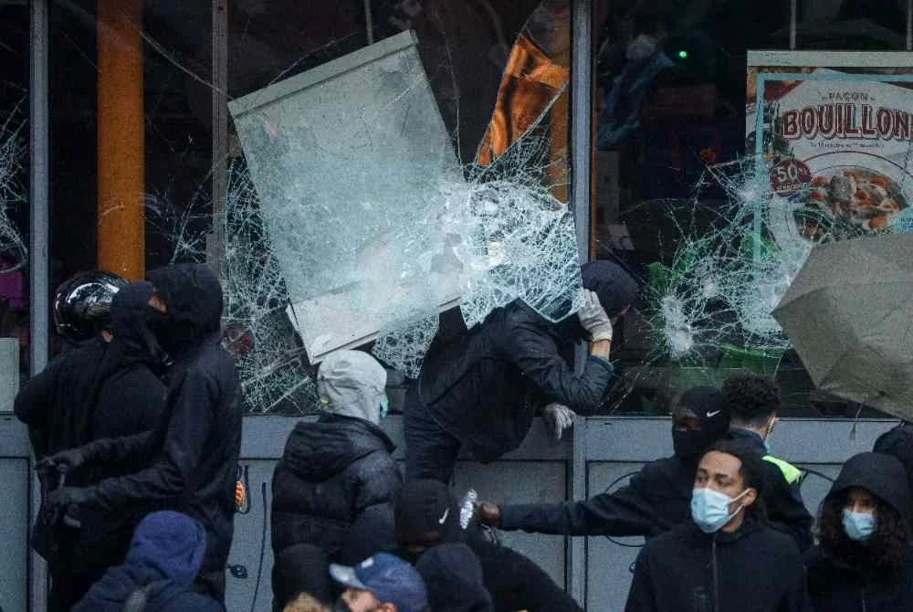 Kumpulan pemuda bertopeng memecah masuk dan menjarah premis perniagaan di Paris pada Sabtu. Foto AFP