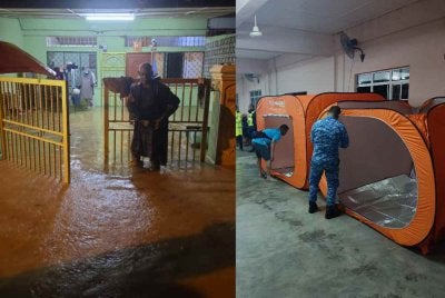 Anggota APM menyiapkan keperluan mangsa yang dipindahkan di PPS Kampung Cheroh. FOTO APM RAUB