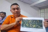 Penolong Pegawai Pertanian Daerah Kinta dan Kampar, Wildan Firdaus Badaruddin menunjukkan peta lot pertanian yang terlibat di sekitar Kampung Redang Sawa dan Kampung Changkat Tualang.