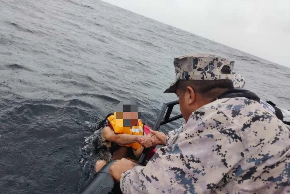Anggota Maritim Malaysia membantu menyelamatkan mangsa yang hanyut selepas kapal korek pasir tenggelam di Kuala Kurau pada Ahad.