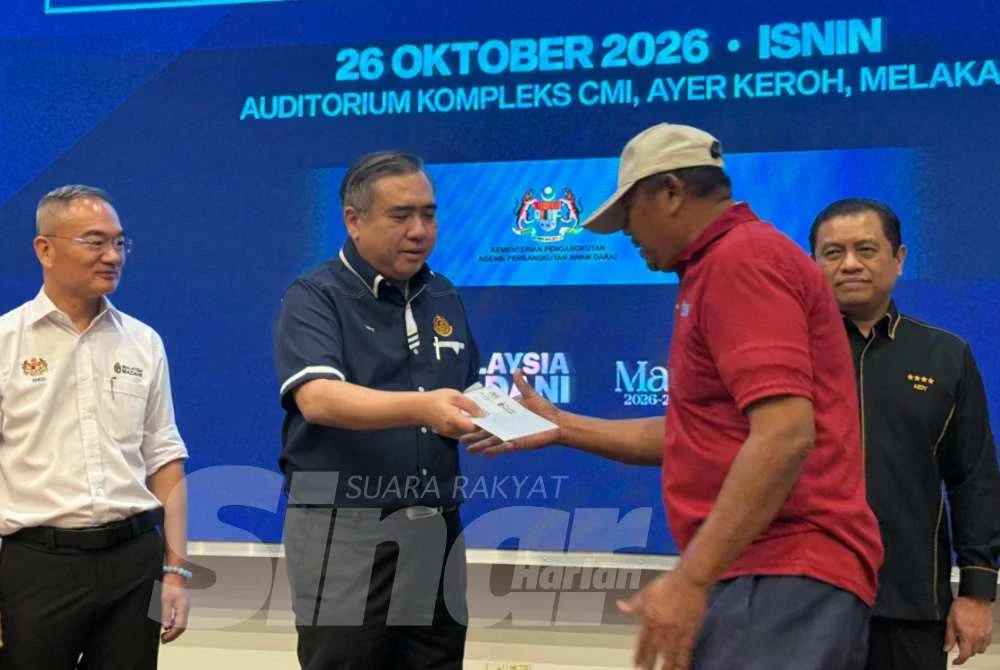 Anthony menyampaikan baucar RM1,000 kepada seorang pemandu teksi. Foto SINAR HARIAN/NORAFIZA JAAFAR
