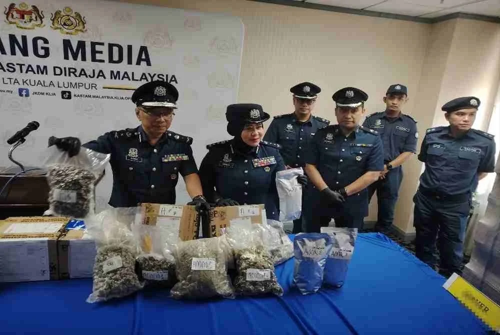 Aspalila (dua dari kiri) menunjukkan dadah jenis bunga ganja yang dirampas JKDM KLIA pada 12 Oktober lalu.